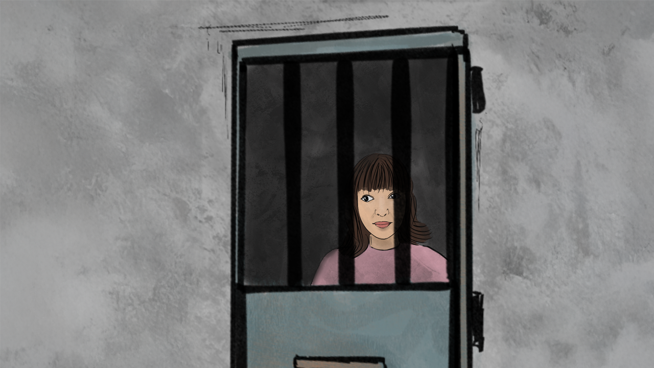 A woman behind bars