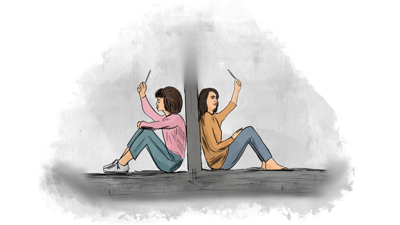 Two female detainees sitting on the floor of a detention cell with pens in their hands