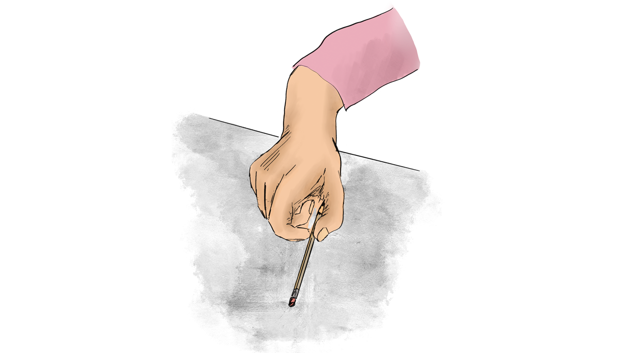 A hand holding a pen, drawing on a desk