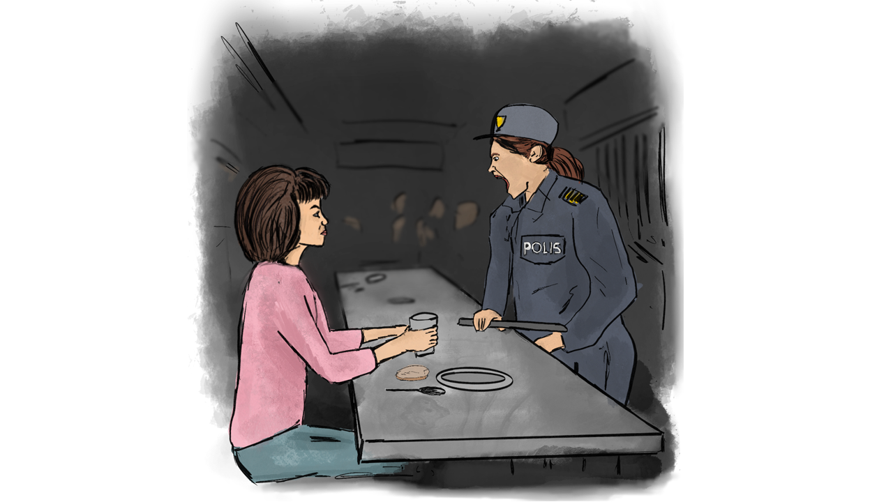 A police officer yelling at a woman seating at a cafeteria table of a detention center